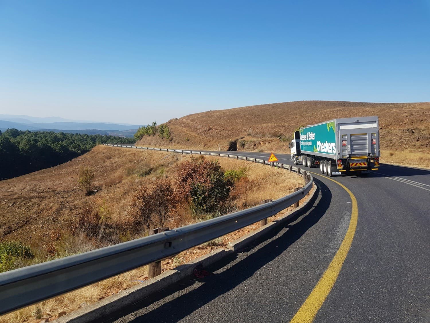 Truck on a highway through dry hill country