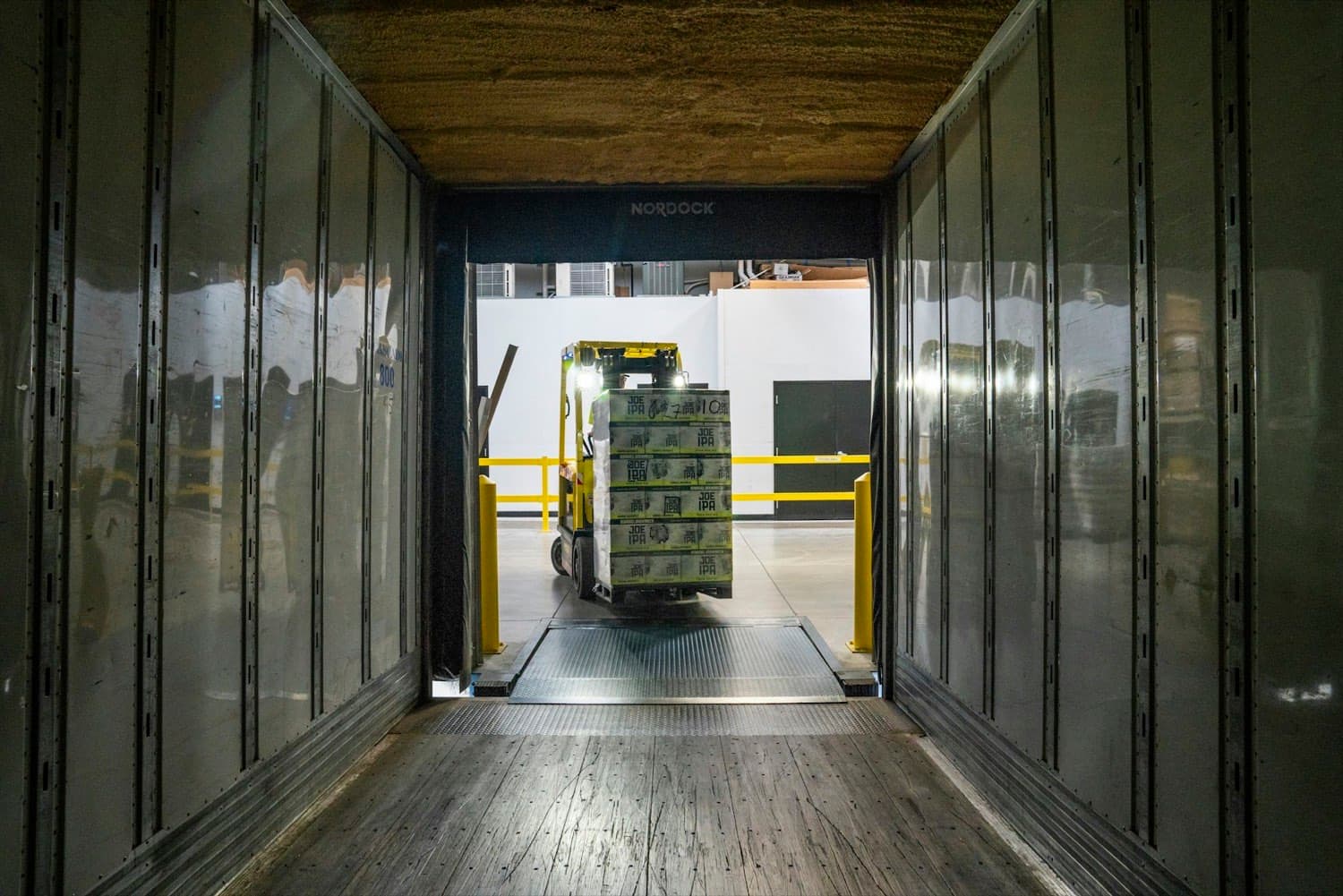 Rigid cargo truck being loaded at a distribution warehouse